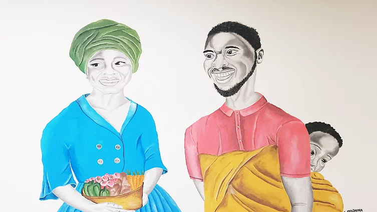 Colourful portrait-style mural showing a woman wearing a green headwrap and blue button-front dress, smiling and holding a basket filled with pink flowers and vegetables. Beside her stands a bearded man in a pink shirt with a baby peeking out from a yellow cloth wrap on his back. Both figures are rendered with grayscale faces against a colourful, illustrated style, with the artist's signature visible in the lower right.